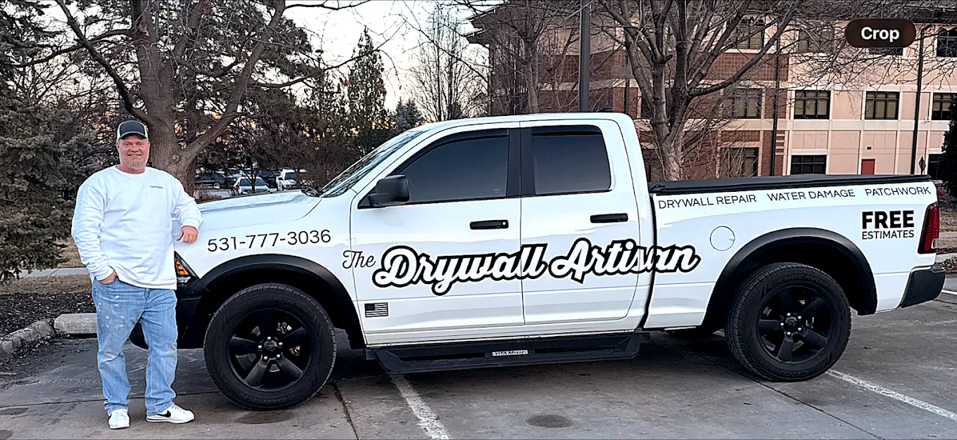Jim — owner of The Drywall Artisan — beside the company truck in Omaha, NE